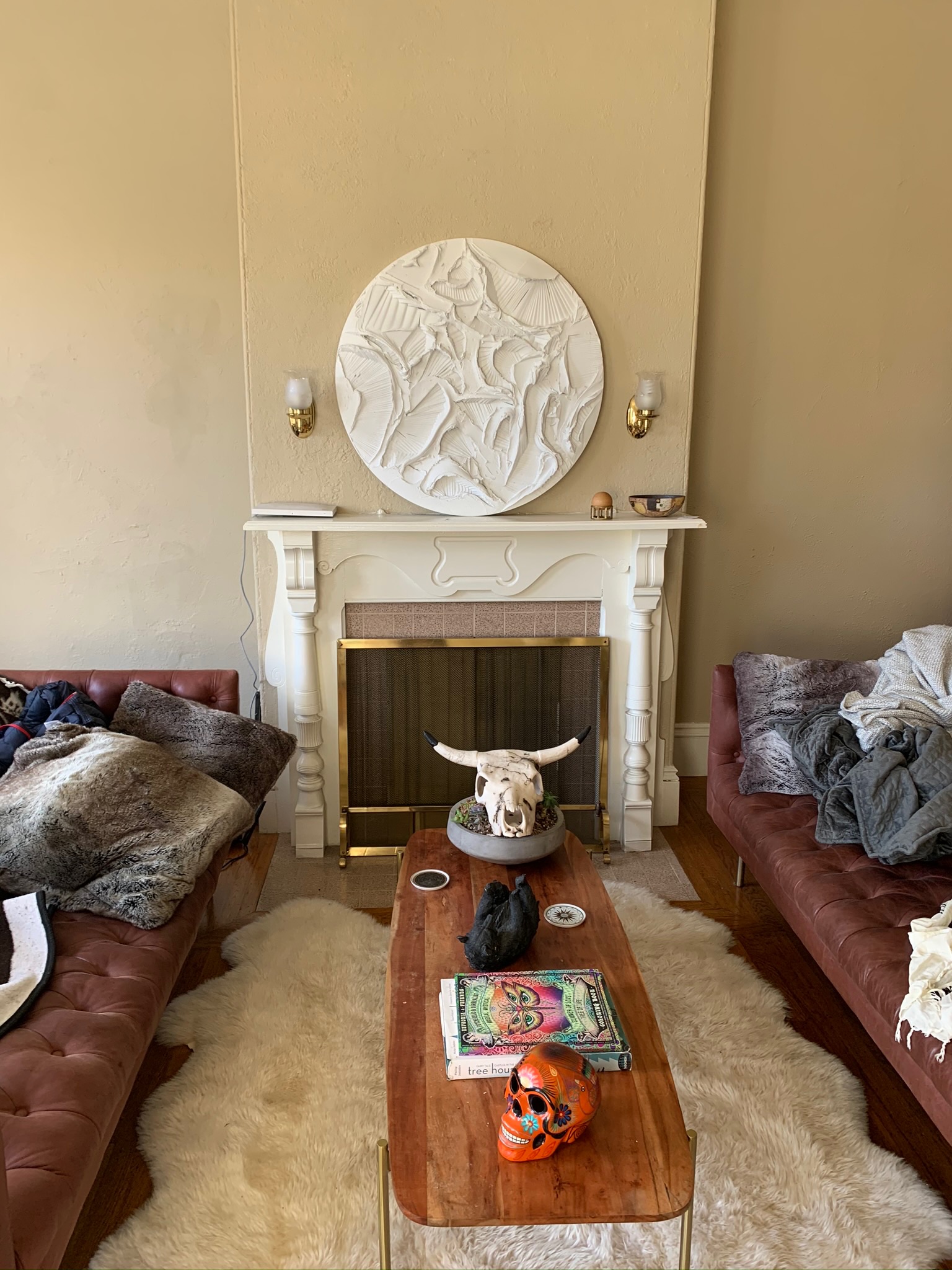 Fireplace with white relief art and bohemian decor